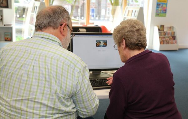 Mike Watson helps Mary Witt get online at Dorchester library