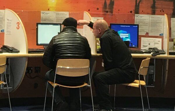A Community Digital Champion helping a customer to get online
