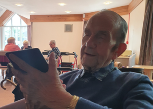 Bob pictured listening to music on his tablet