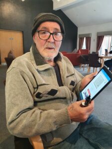 Bob using his tablet to access online auctions