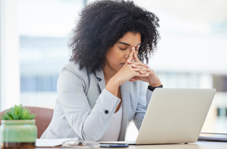 a woman stressed at a laptop